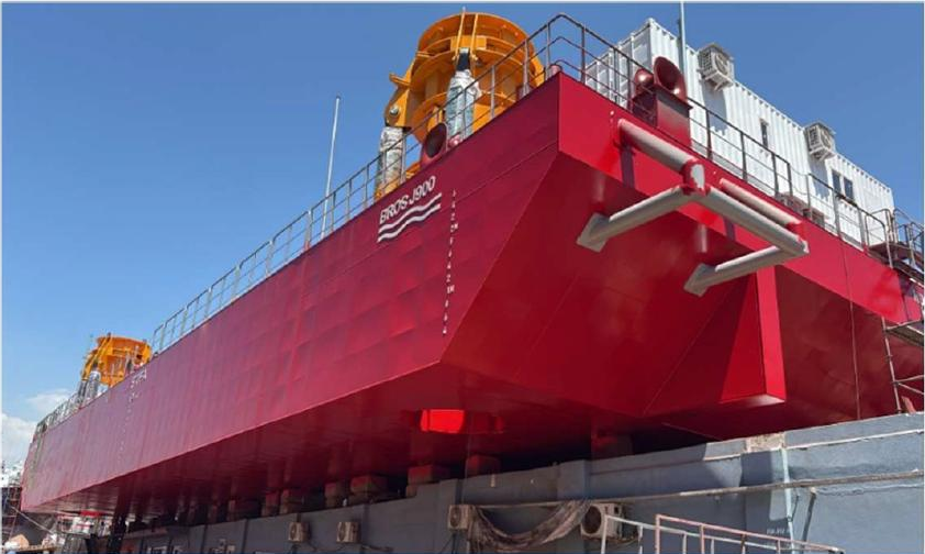 Bow view of the red BROS J900 jack-up barge with its four legs installed
